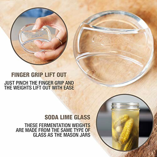 Glass fermentation weight with finger grip and jar of pickles.