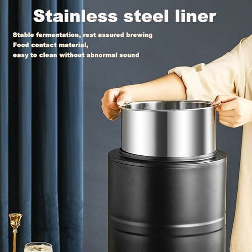 Person placing stainless steel liner on black container.