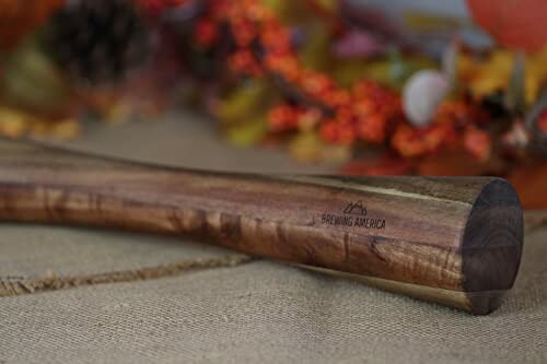 Close-up of a wooden bat handle on a table.